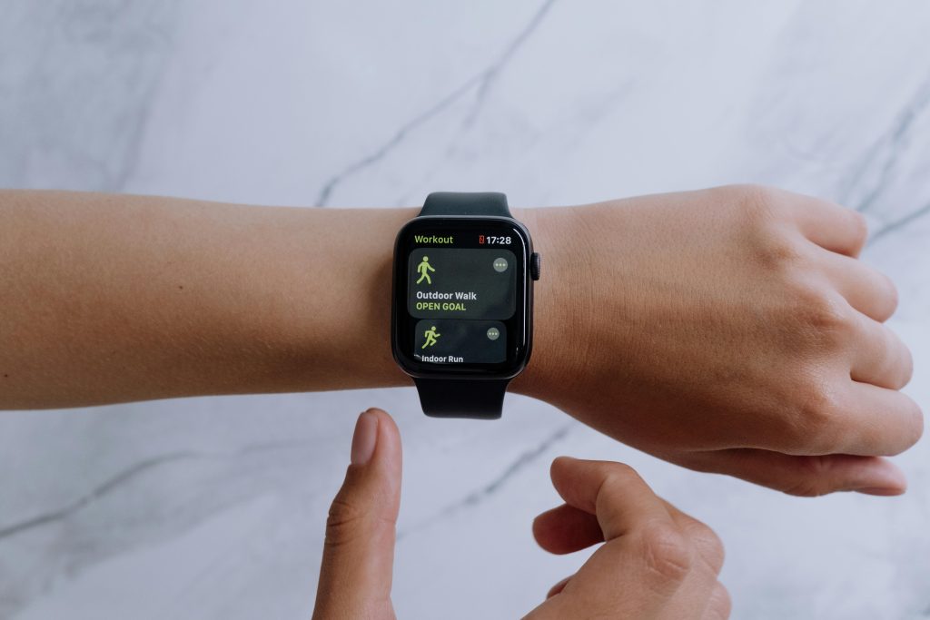 Fitbit Sense 2 smartwatch on hand showing workout tracking data