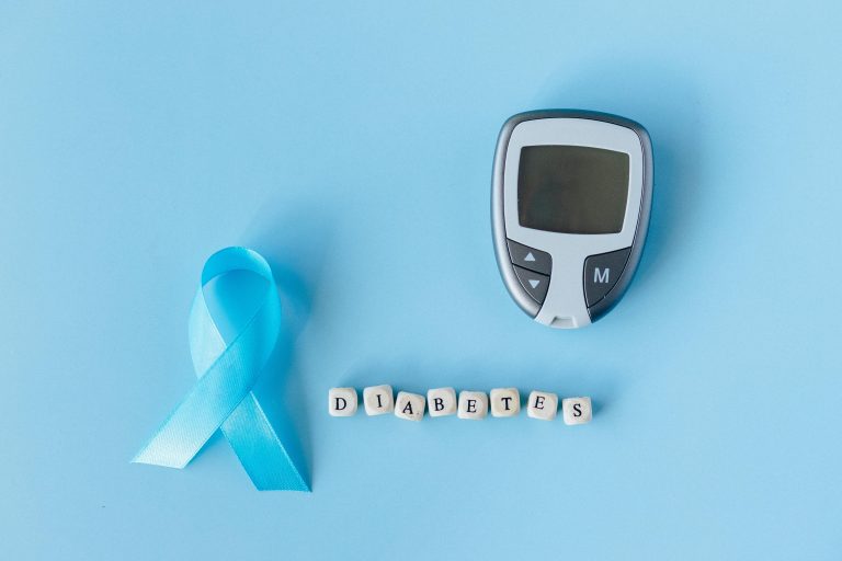 Smart Glucometer Diabetes Gadgets with blue awareness ribbon for management