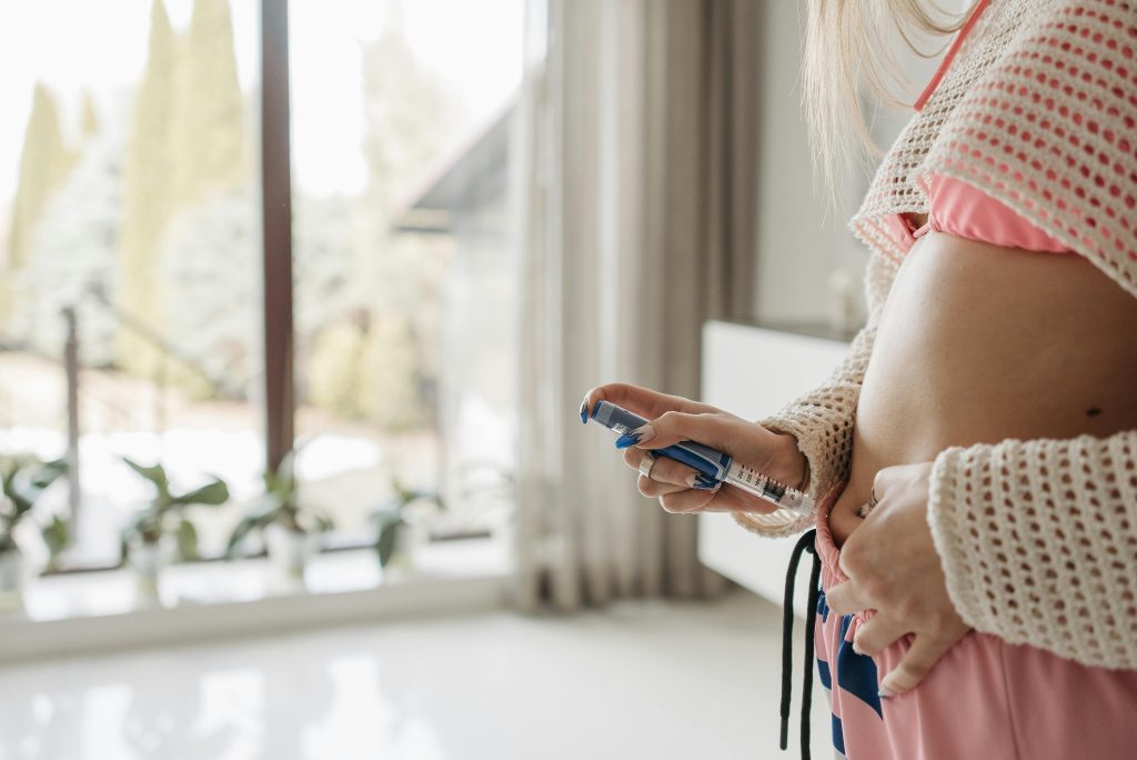 Woman using a smart insulin pen for accurate dose administration